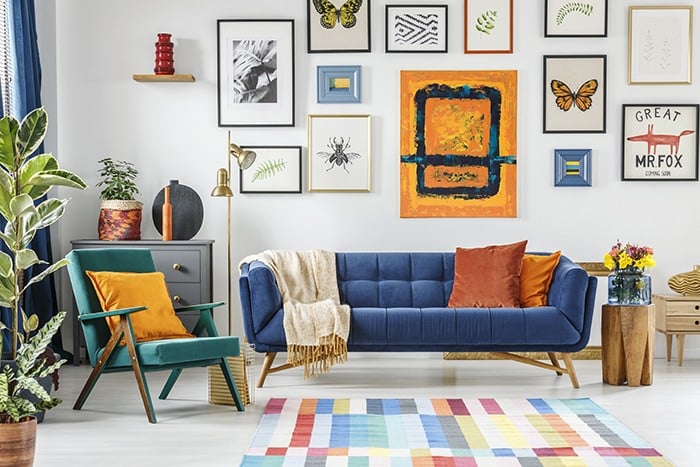 Green armchair next to blue settee in colorful living room inter Interior Decoration